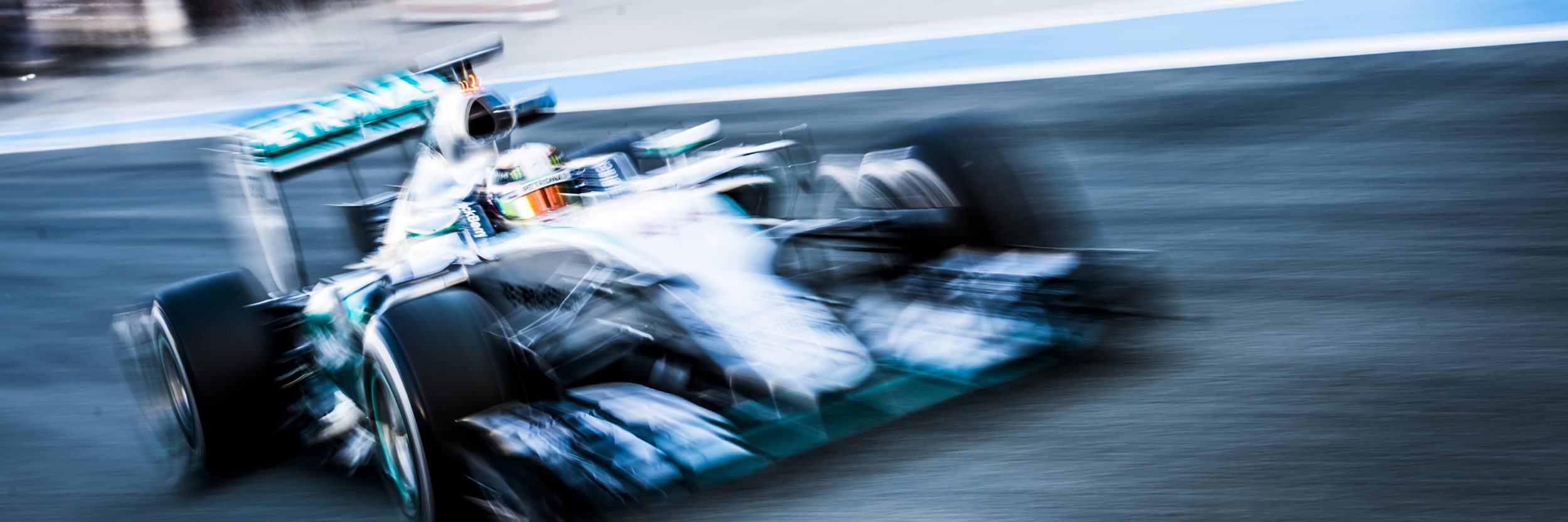 Formula 1 car racing down track with motion blur