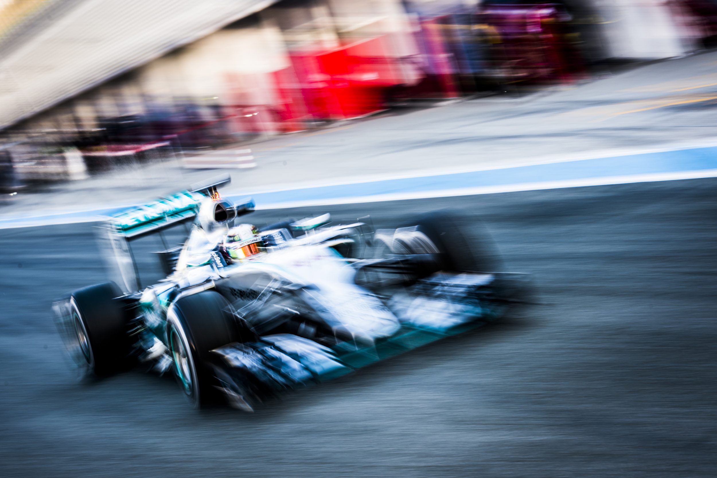 Formula 1 car racing down track with motion blur